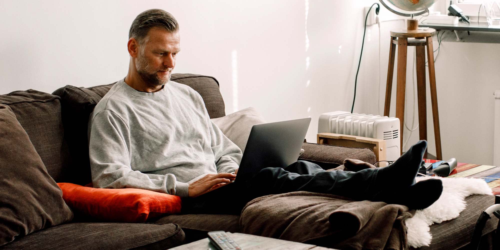 Man sitting on couch with laptop