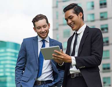 Business people in suits looking at tablet