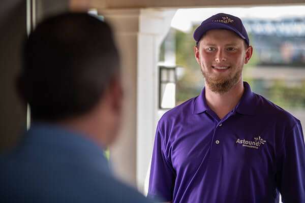 Astound technician at customer door