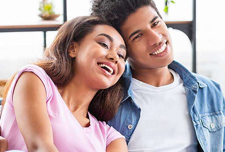 Family laughing on couch